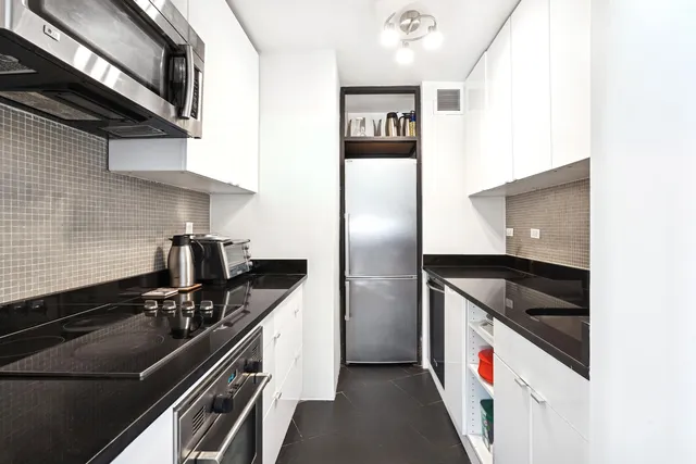 a bedroom with furniture and a large window