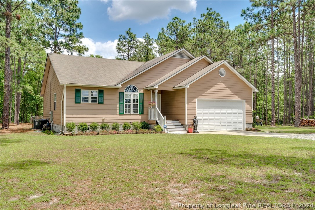 3590 Calloway Road Raeford, NC 28376 - Photo 1 of 44 a front view of a house with a garden