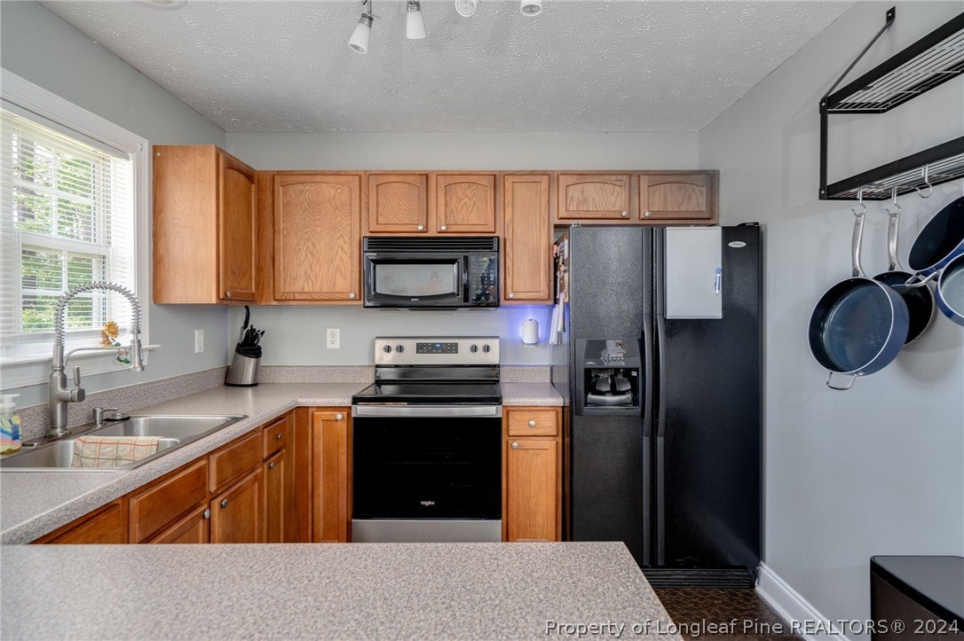 3590 Calloway Road Raeford, NC 28376 - Photo 11 of 44 a kitchen with stainless steel appliances granite countertop a refrigerator stove and sink