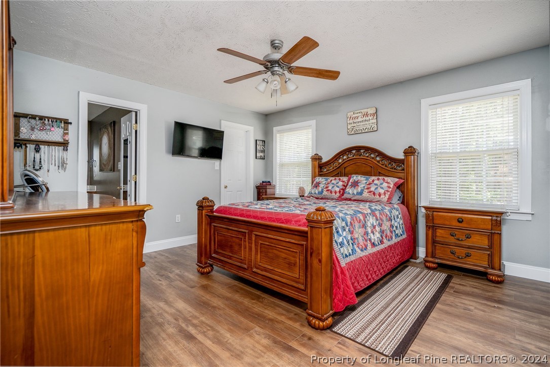 3590 Calloway Road Raeford, NC 28376 - Photo 13 of 44 a bedroom with a bed and a chandelier