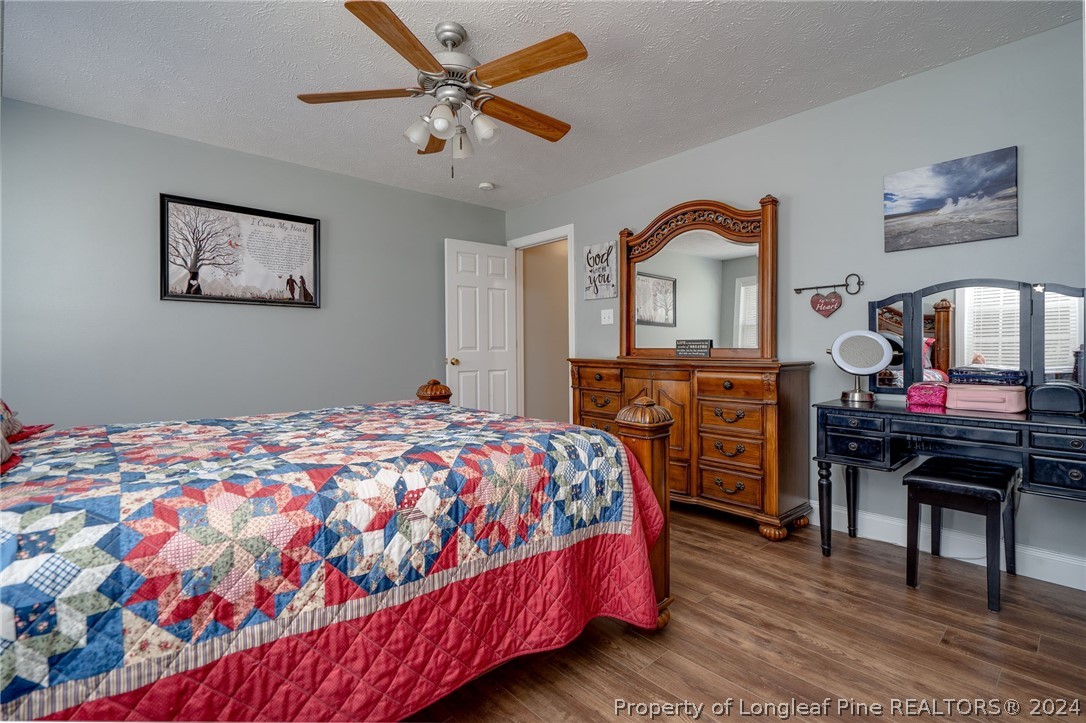 3590 Calloway Road Raeford, NC 28376 - Photo 14 of 44 a bedroom with a bed and a dresser in it