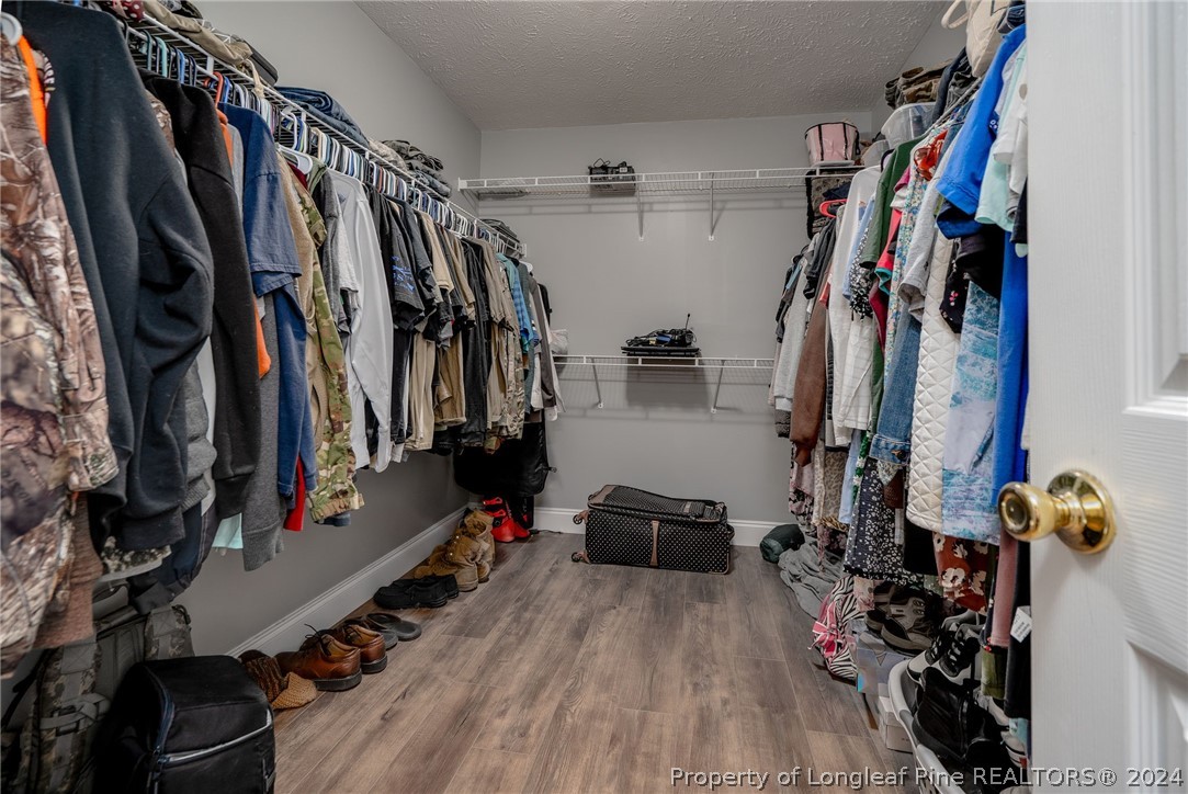 3590 Calloway Road Raeford, NC 28376 - Photo 15 of 44 a view of walk in closet with clothes and shoes