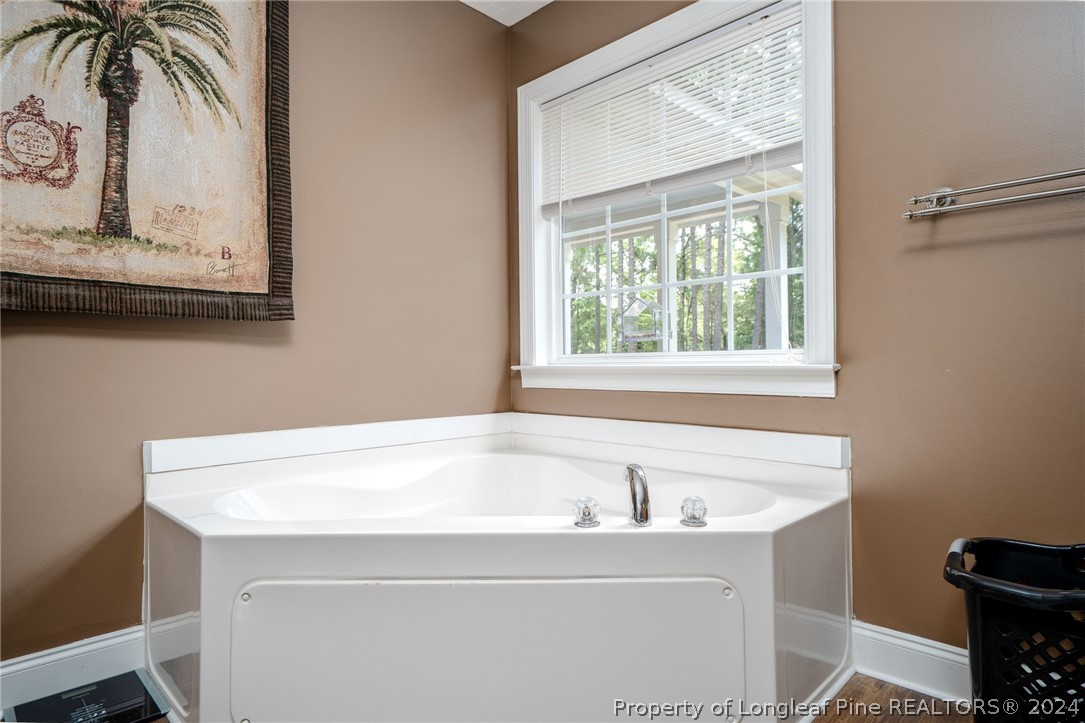 3590 Calloway Road Raeford, NC 28376 - Photo 20 of 44 a bathroom with a bathtub and a window