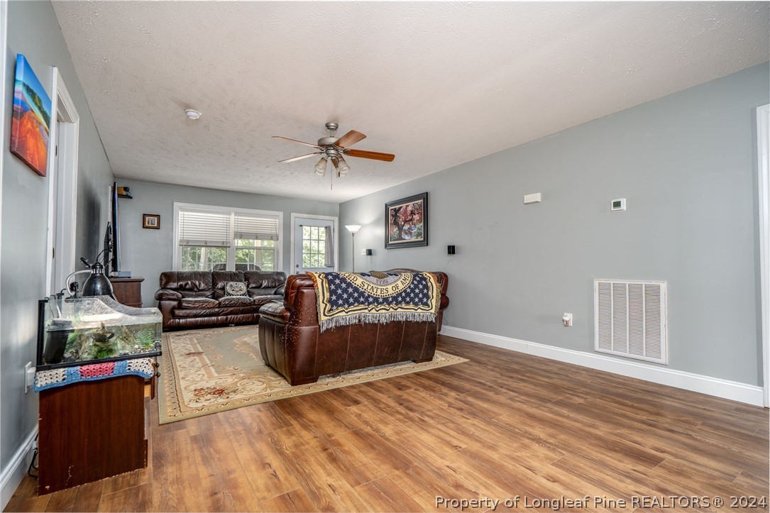 3590 Calloway Road Raeford, NC 28376 - Photo 25 of 44 a living room with furniture and a wooden floor