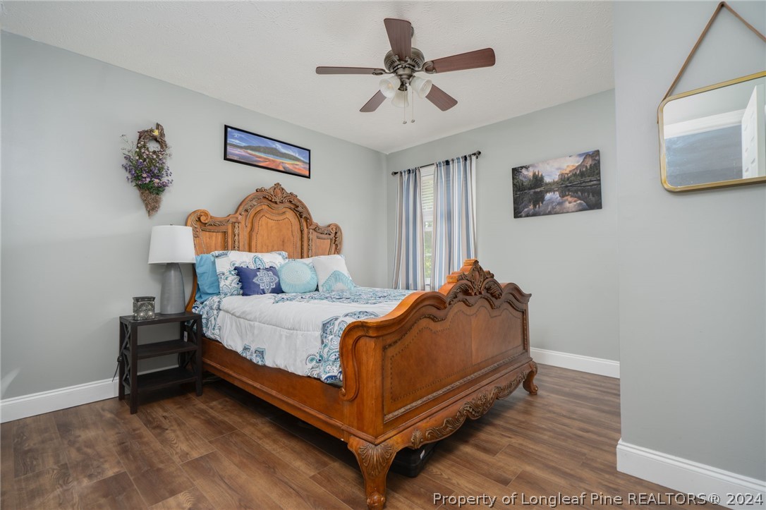 3590 Calloway Road Raeford, NC 28376 - Photo 26 of 44 a bed room with a bed and a ceiling fan