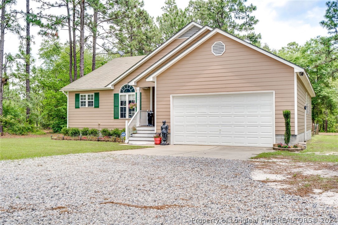 3590 Calloway Road Raeford, NC 28376 - Photo 3 of 44 a view of a house with a yard and garage