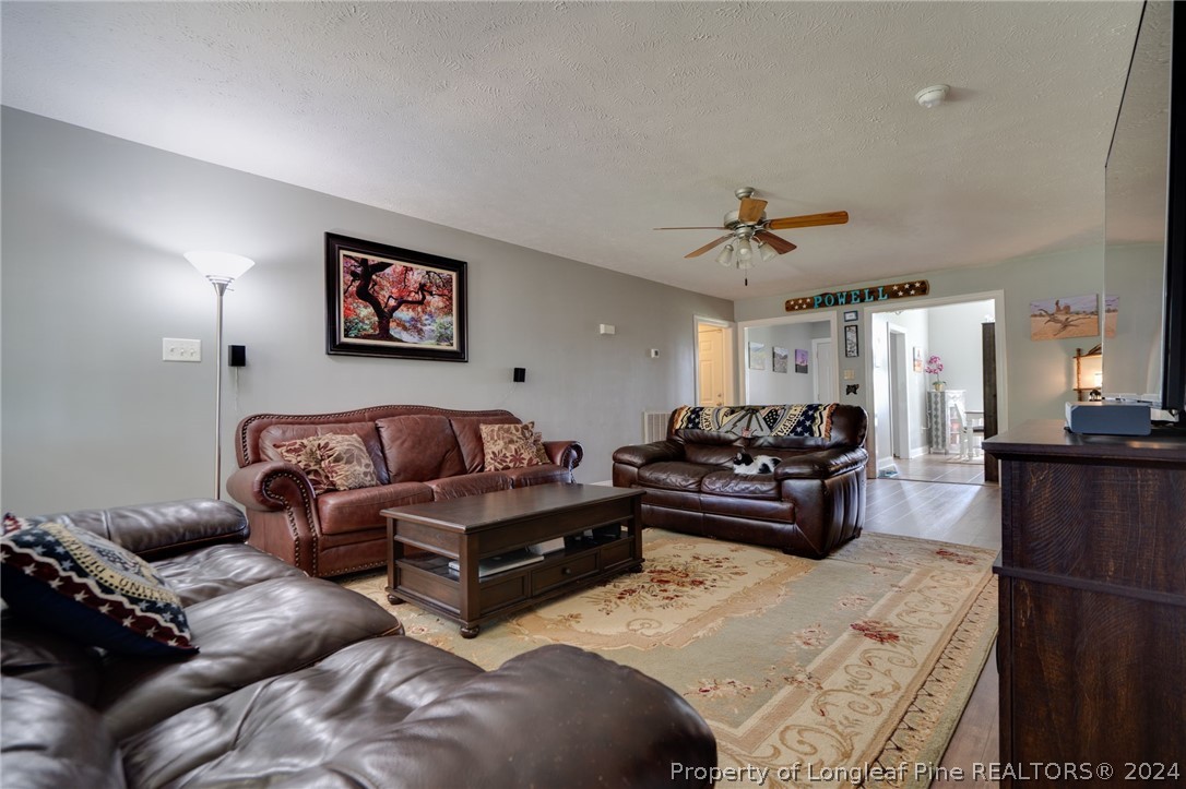 3590 Calloway Road Raeford, NC 28376 - Photo 31 of 44 a living room with furniture a couch and a chandelier
