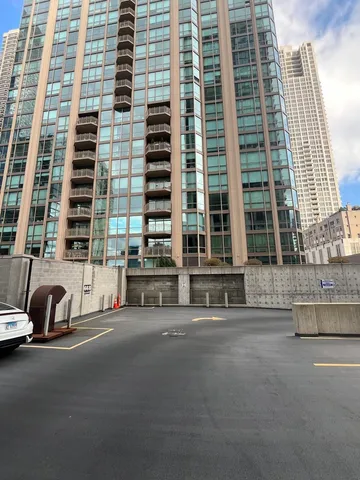 a couple of cars parked in front of a building