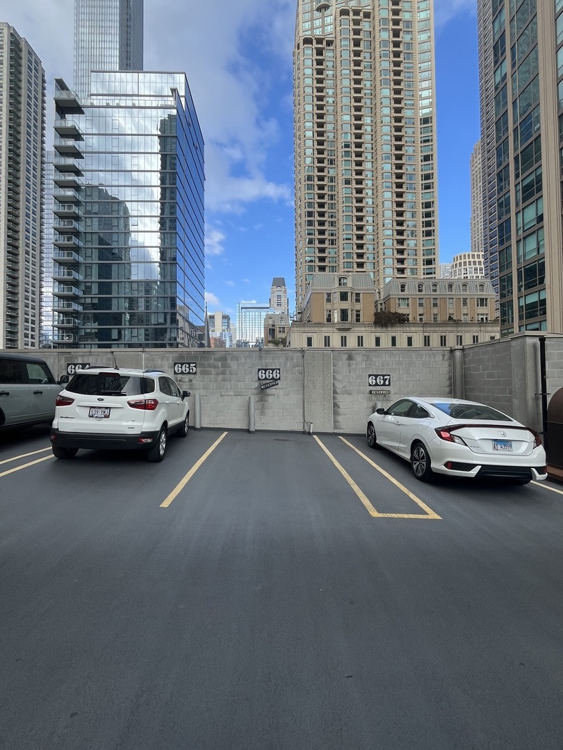 2 East Erie Street, Unit 666 Chicago, IL 60611 - Photo 5 of 5 a view of city street with cars parked in front of it