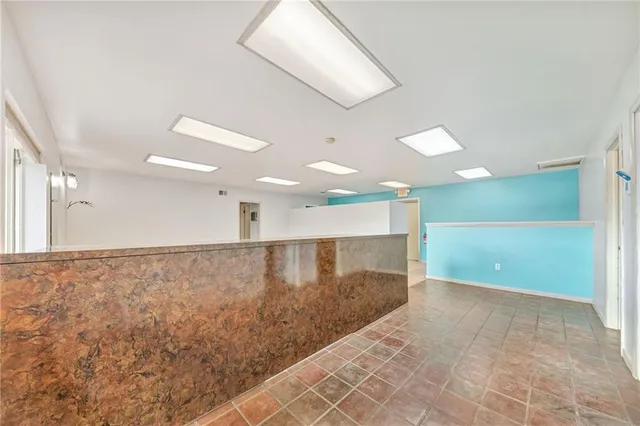 an empty room with a ceiling fan and window