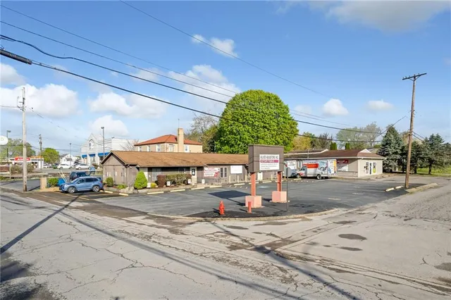 a large white kitchen with stainless steel appliances kitchen island granite countertop a lot of cabinets