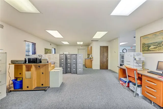 a large white room with furniture and a large window