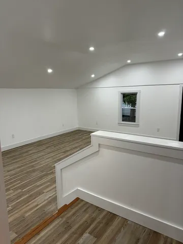 a view of storage and utility room with wooden floor