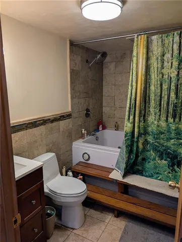 a bathroom with a toilet a sink and tub