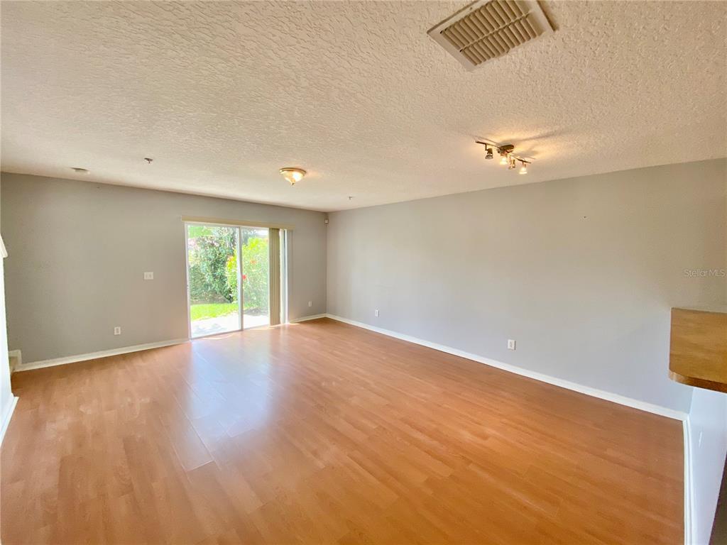 13540 Tea Rose Way, Unit 120 Orlando, FL 32824 - Photo 3 of 6 a view of empty room with wooden floor and fan