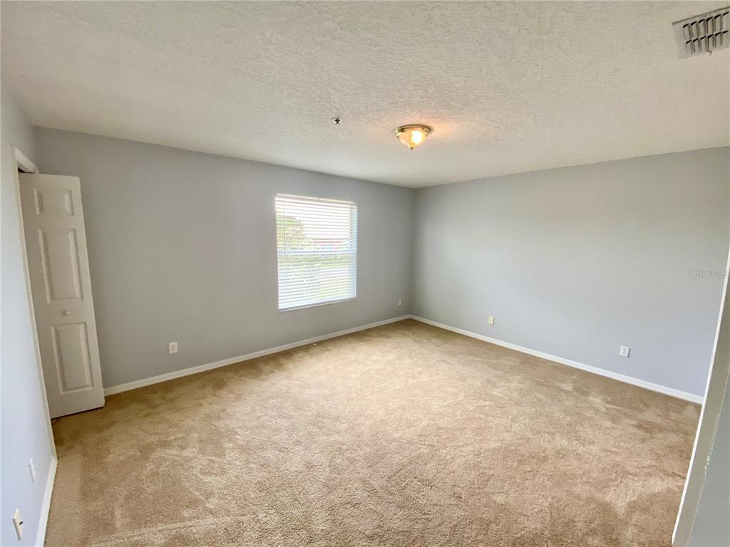 13540 Tea Rose Way, Unit 120 Orlando, FL 32824 - Photo 4 of 6 an empty room with a window
