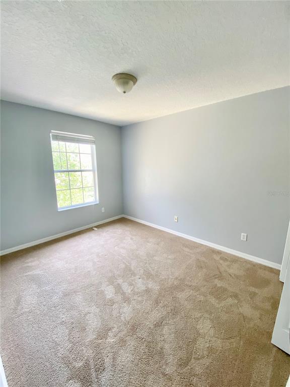 13540 Tea Rose Way, Unit 120 Orlando, FL 32824 - Photo 6 of 6 an empty room with windows