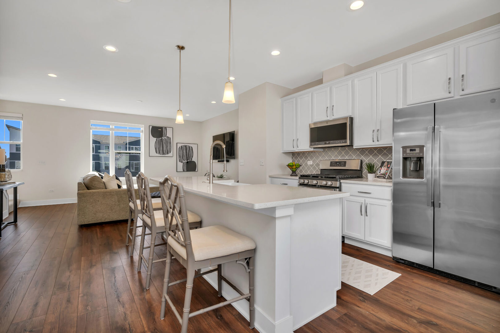 4133 Calder Lane Aurora, IL 60504 - Photo 7 of 31 a kitchen with stainless steel appliances granite countertop a refrigerator a stove top oven a sink dishwasher a dining table and chairs with wooden floor