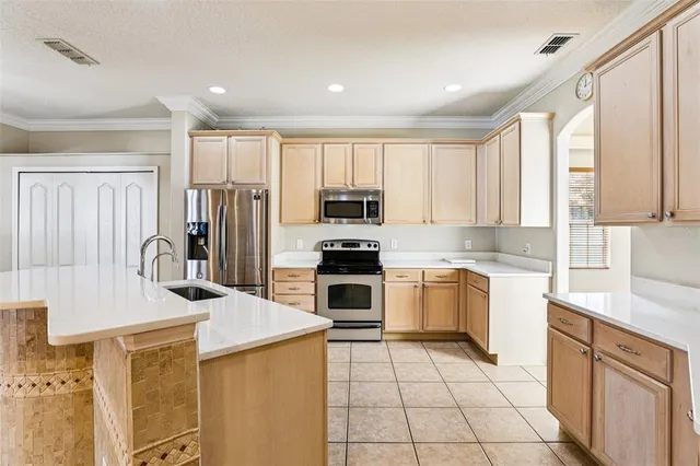 a kitchen with a sink refrigerator and cabinets