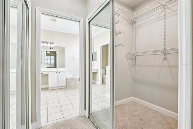 an empty room with ceiling fan and window