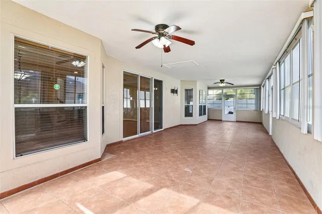 a view of a swimming pool with a table and chairs under an umbrella