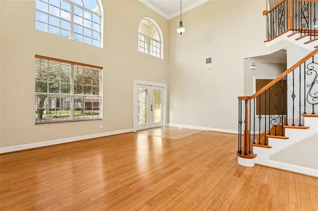 a view of an entryway with wooden floor and door