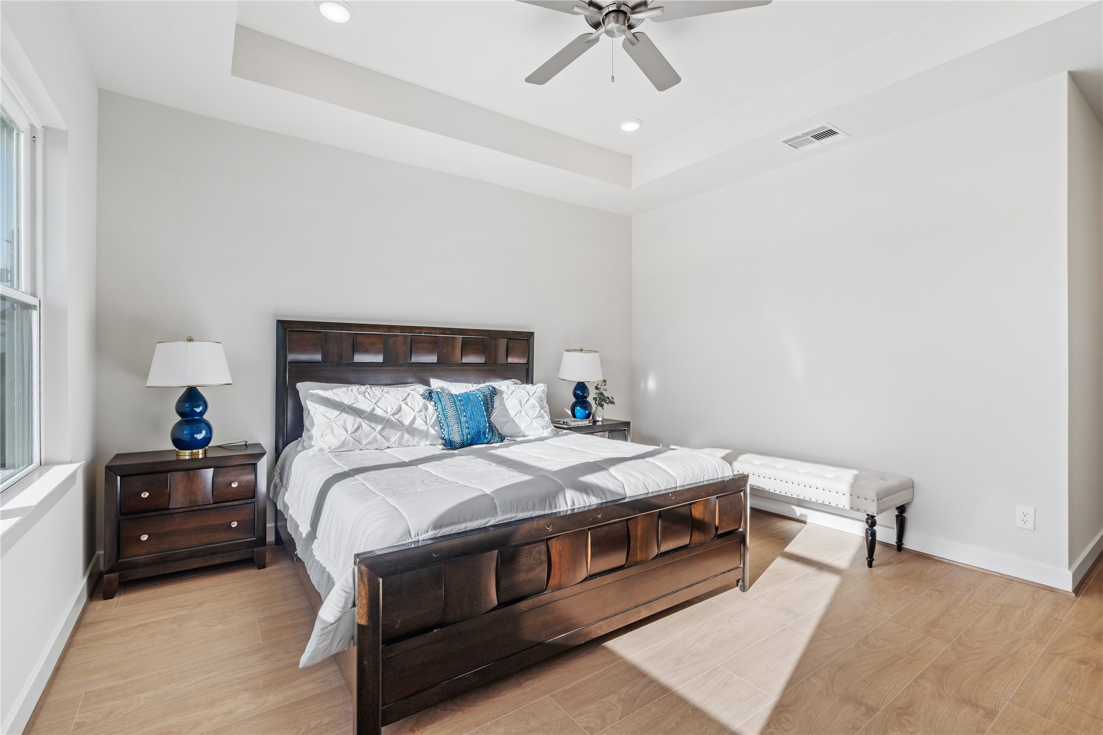 6505 Rena Street Houston, TX 77092 - Photo 16 of 28 Clean wall lines and steady natural light from the side window keep the primary suite feeling open and relaxed rather than closed off.