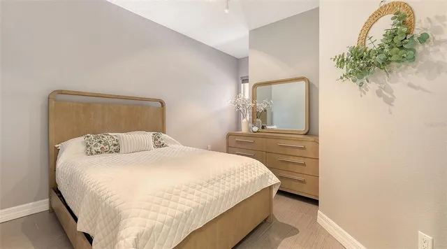 a bedroom with a bed and a mirror