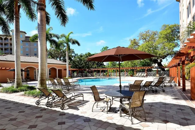 a view of a patio with table and chairs under an umbrella