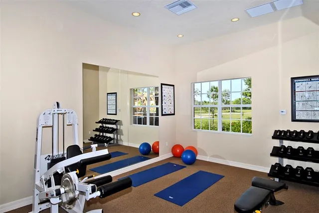 a room with furniture and gym equipment