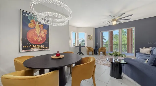 a view of a dining room with furniture wooden floor and a chandelier