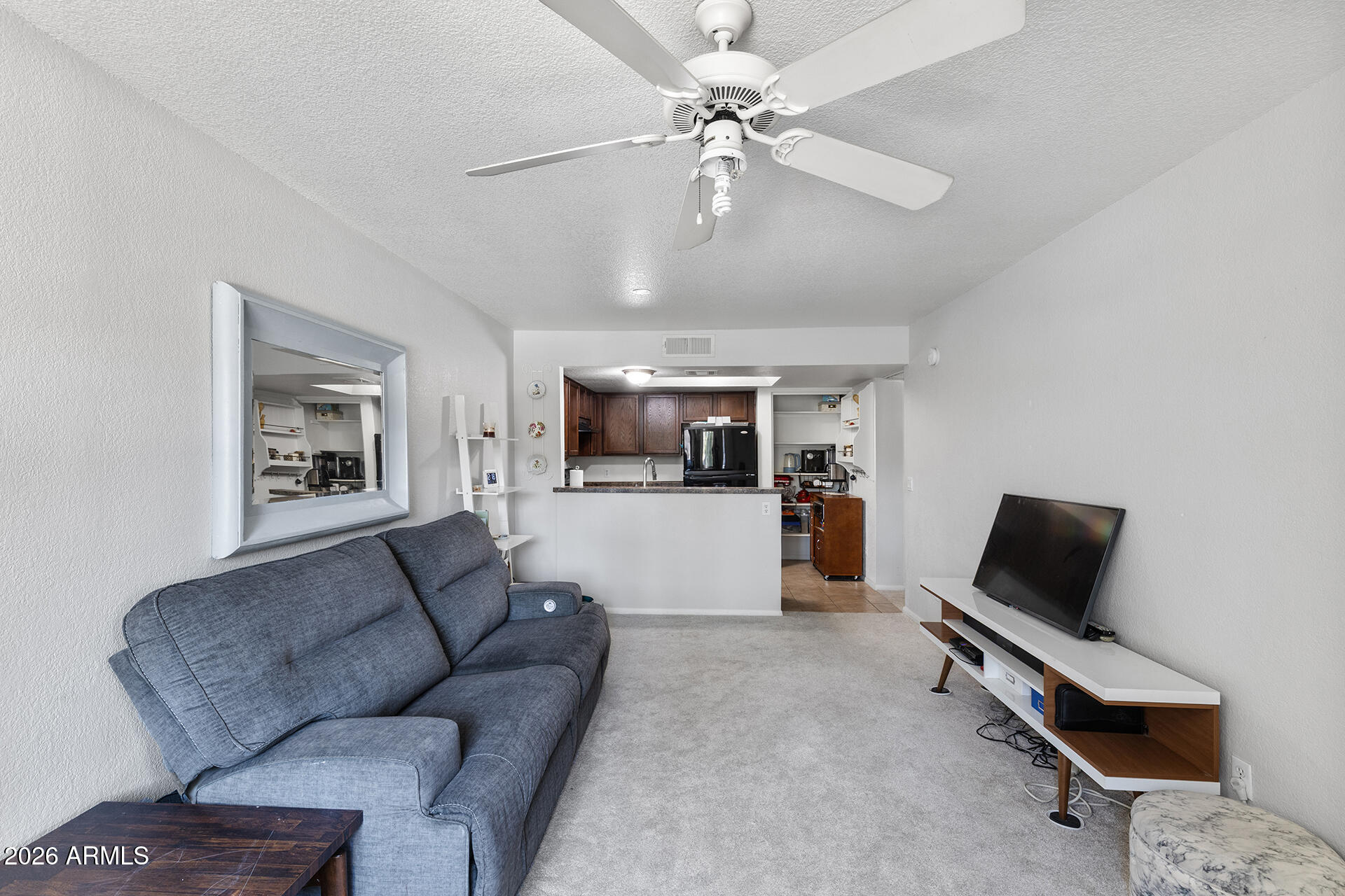 1720 East Thunderbird Road, Unit 2063 Phoenix, AZ 85022 - Photo 16 of 32 a living room with furniture and a ceiling fan