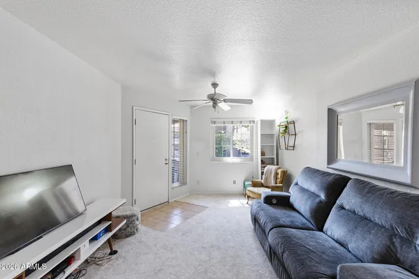 a living room with furniture and a chandelier