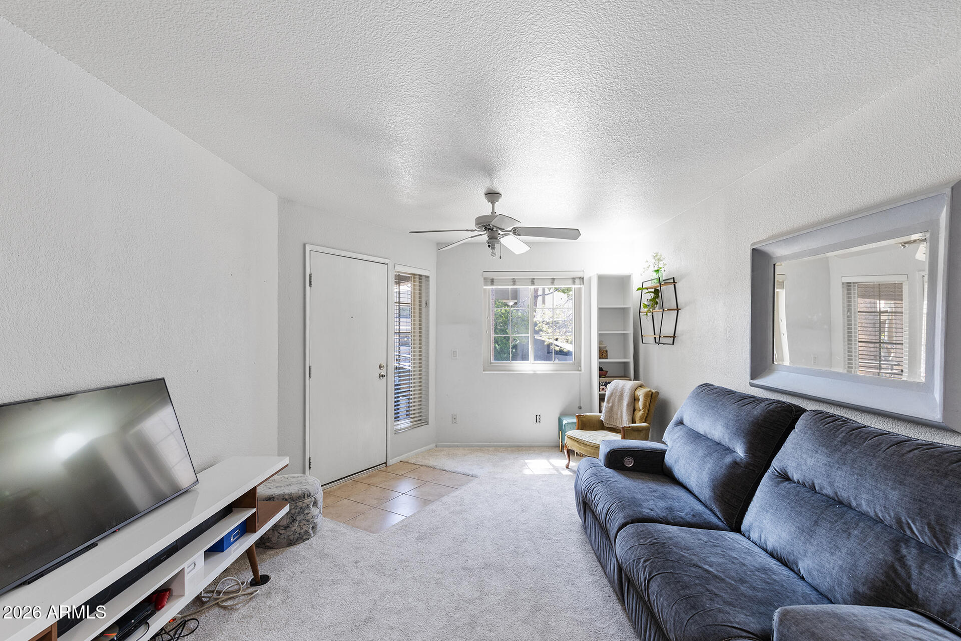 1720 East Thunderbird Road, Unit 2063 Phoenix, AZ 85022 - Photo 18 of 32 a living room with furniture and a flat screen tv