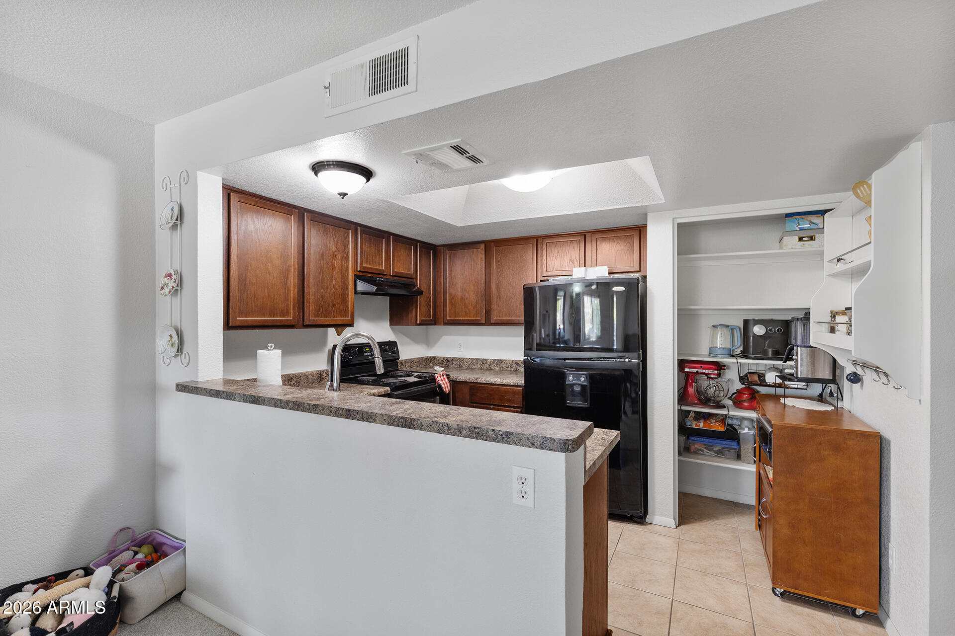 1720 East Thunderbird Road, Unit 2063 Phoenix, AZ 85022 - Photo 19 of 32 a kitchen with kitchen island a counter top space appliances and a sink