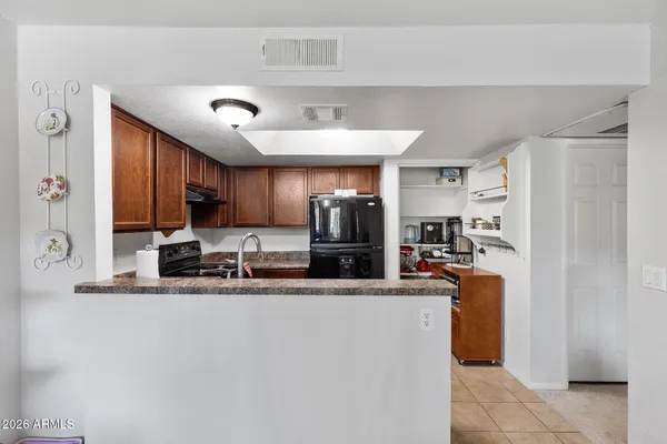 a kitchen with kitchen island a counter top space appliances and a sink