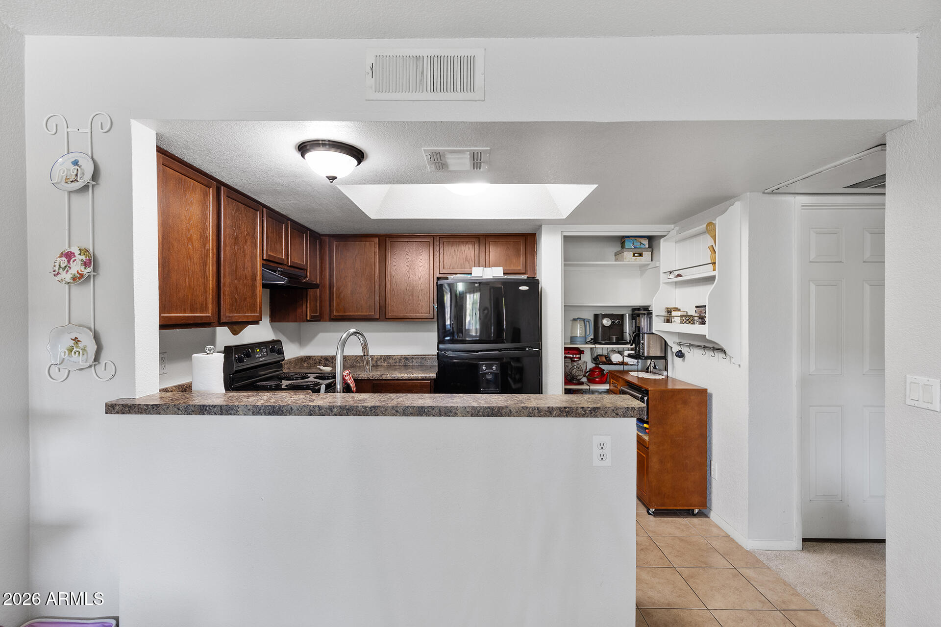 1720 East Thunderbird Road, Unit 2063 Phoenix, AZ 85022 - Photo 20 of 32 a kitchen with stainless steel appliances granite countertop a sink refrigerator and cabinets