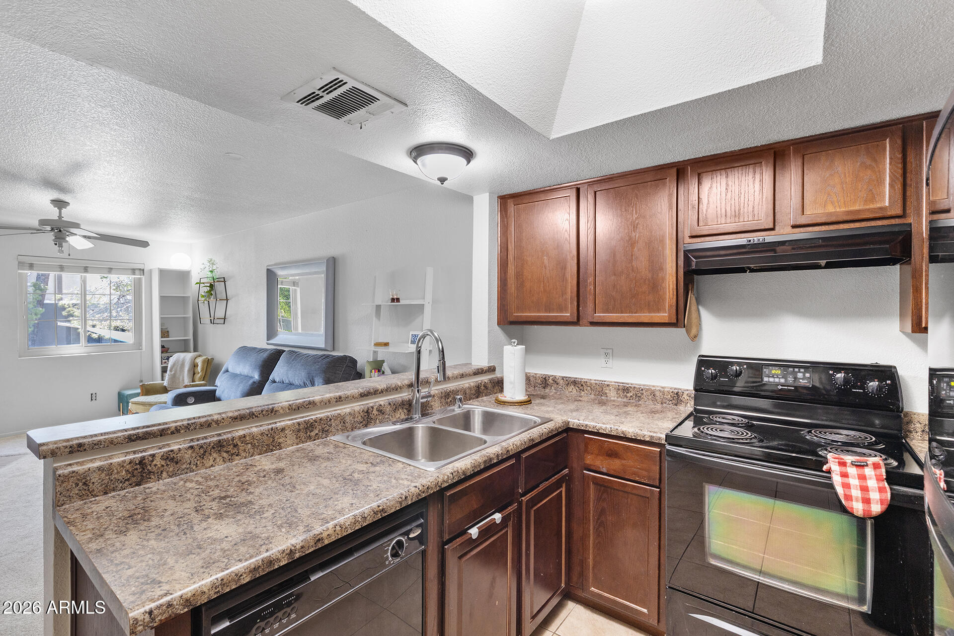 1720 East Thunderbird Road, Unit 2063 Phoenix, AZ 85022 - Photo 21 of 32 a kitchen with granite countertop stainless steel appliances and sink