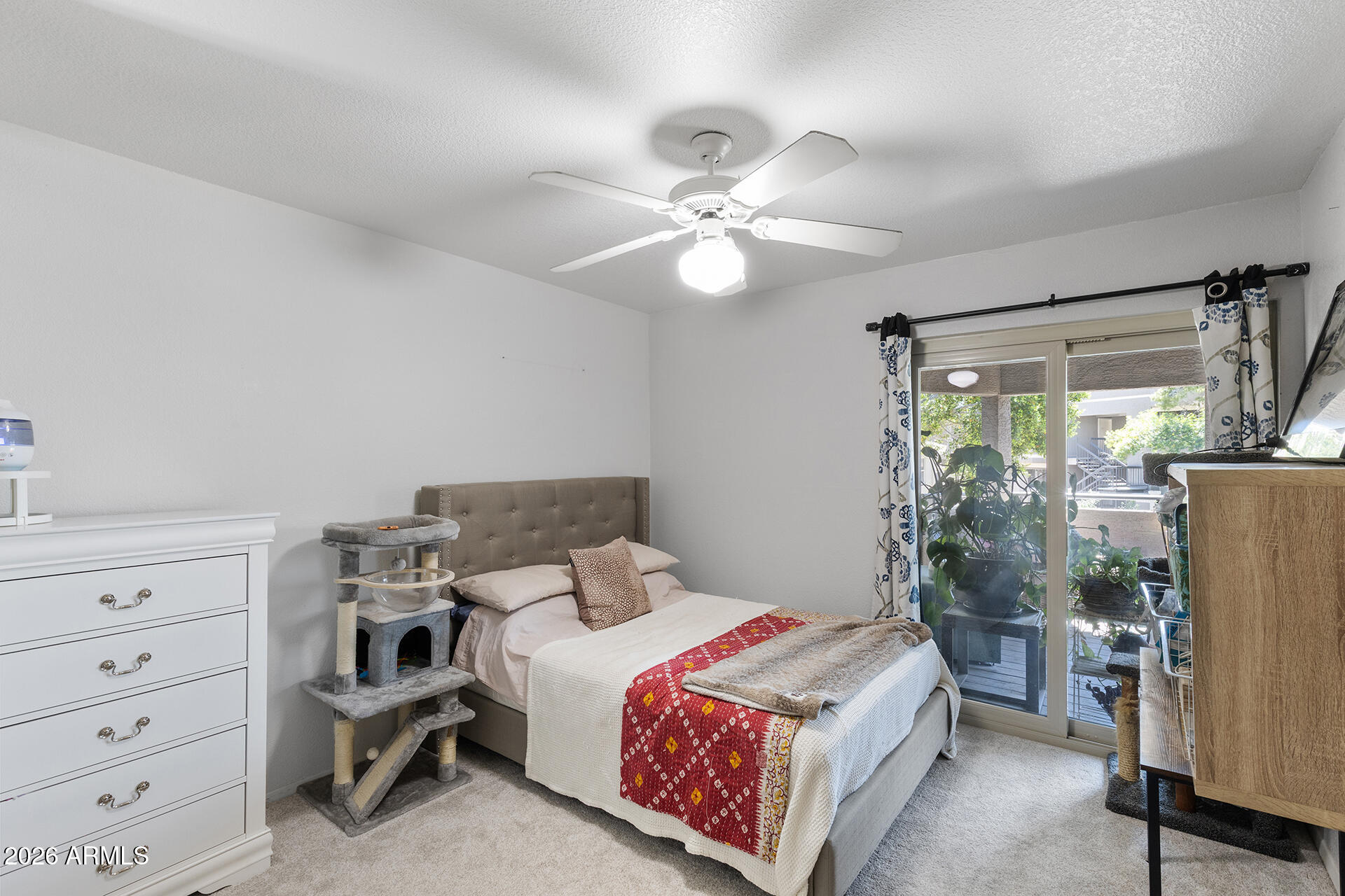 1720 East Thunderbird Road, Unit 2063 Phoenix, AZ 85022 - Photo 25 of 32 a bedroom with a bed and a chandelier