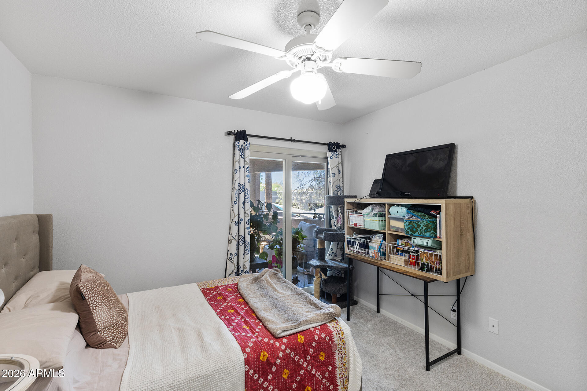 1720 East Thunderbird Road, Unit 2063 Phoenix, AZ 85022 - Photo 26 of 32 a bedroom with a bed and a chandelier