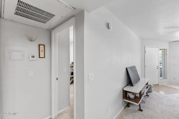a living room with furniture and a ceiling fan