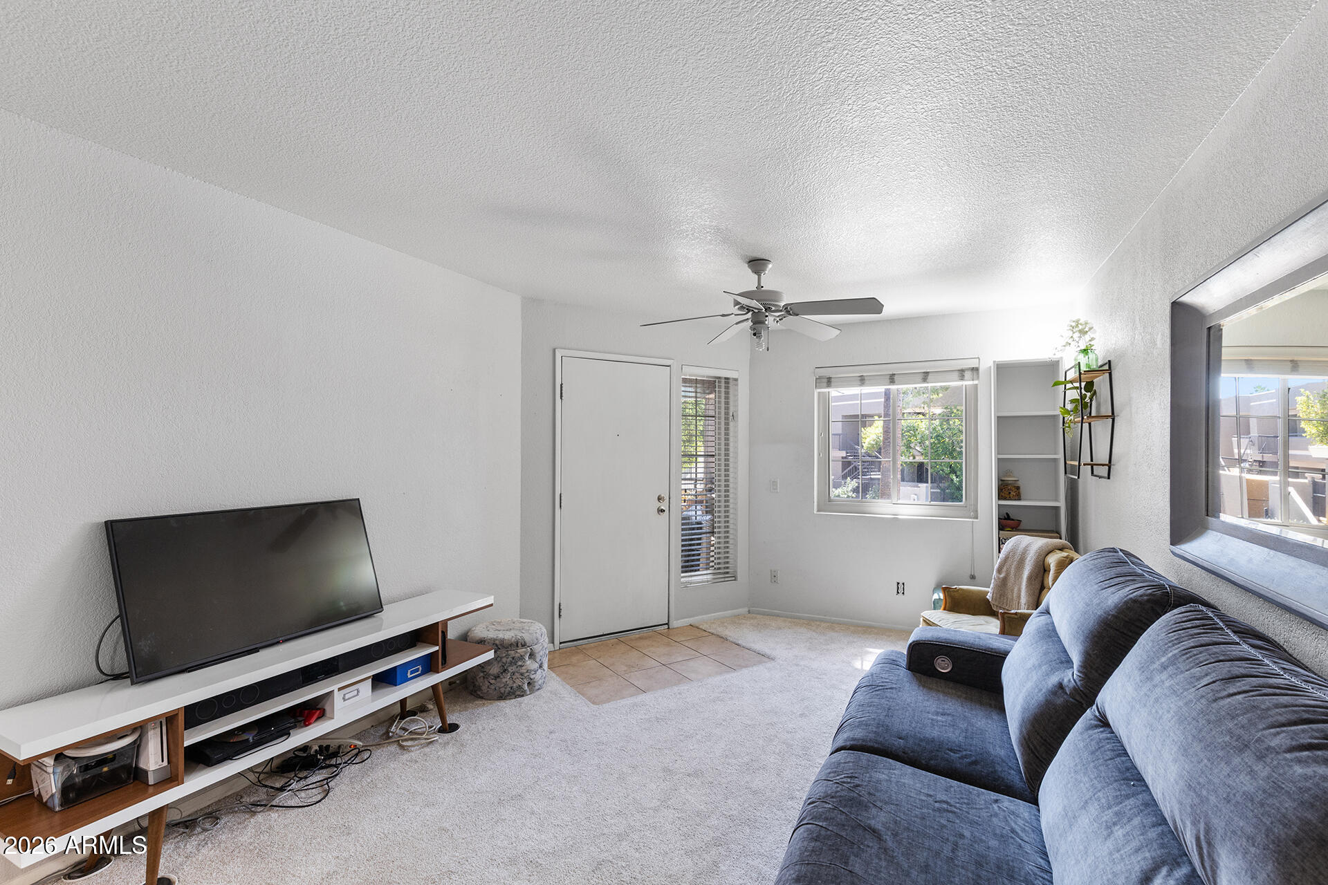 1720 East Thunderbird Road, Unit 2063 Phoenix, AZ 85022 - Photo 3 of 32 a living room with furniture and a flat screen tv
