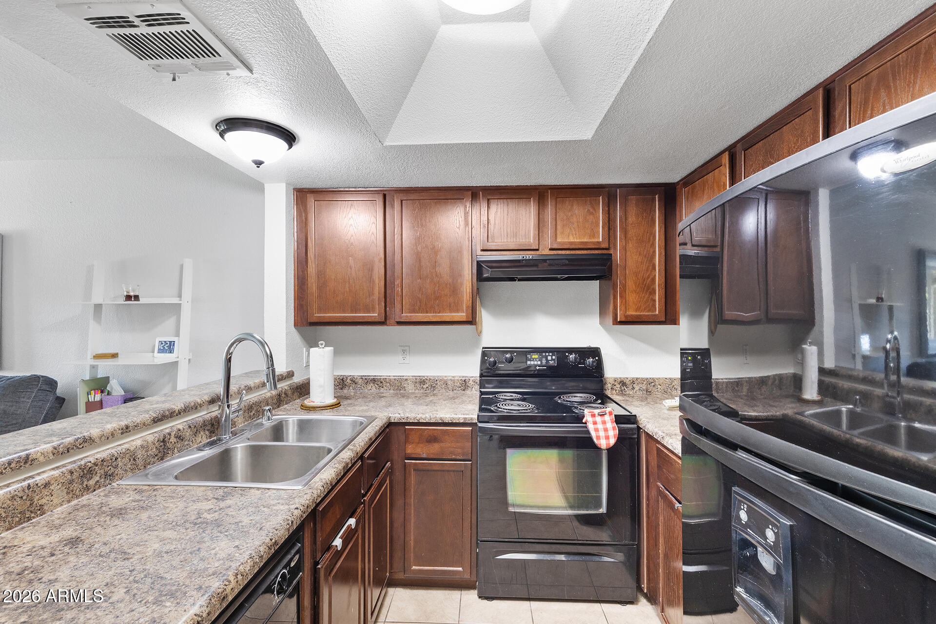 1720 East Thunderbird Road, Unit 2063 Phoenix, AZ 85022 - Photo 4 of 32 a kitchen with granite countertop a sink stove and cabinets