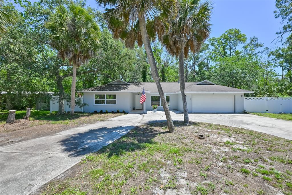 1578 Indian Bay Road Spring Hill, FL 34607 - Photo 2 of 51 a backyard of a house with plants and tree