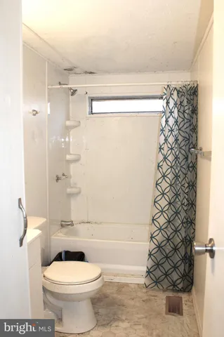 a bathroom with a shower and a toilet