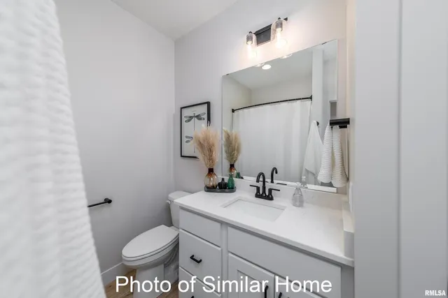 a bathroom with a sink toilet and mirror
