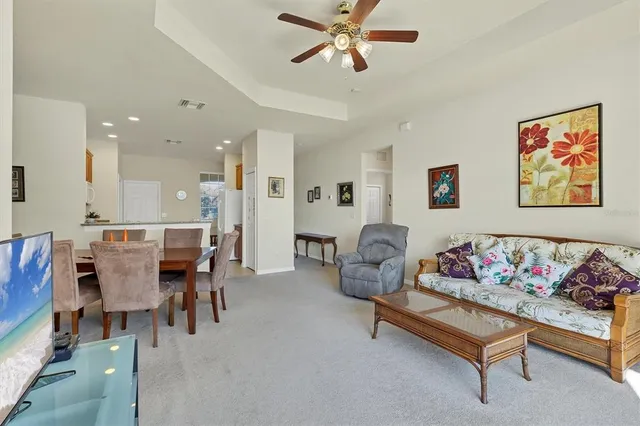 a living room with furniture and kitchen view
