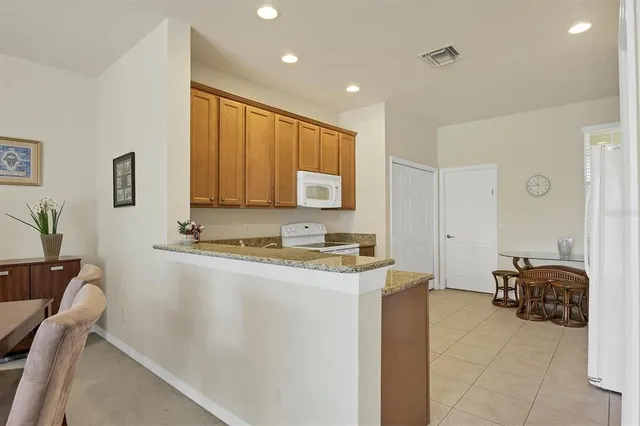a view of kitchen with stainless steel appliances granite countertop sink stove and cabinets