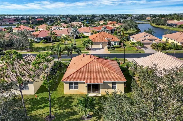 an aerial view of residential houses and lake view