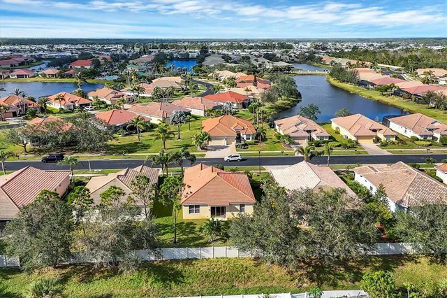 an aerial view of residential houses with outdoor space and swimming pool